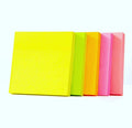 Assorted fluorescent sticky note pads in yellow, green, orange, pink, and coral